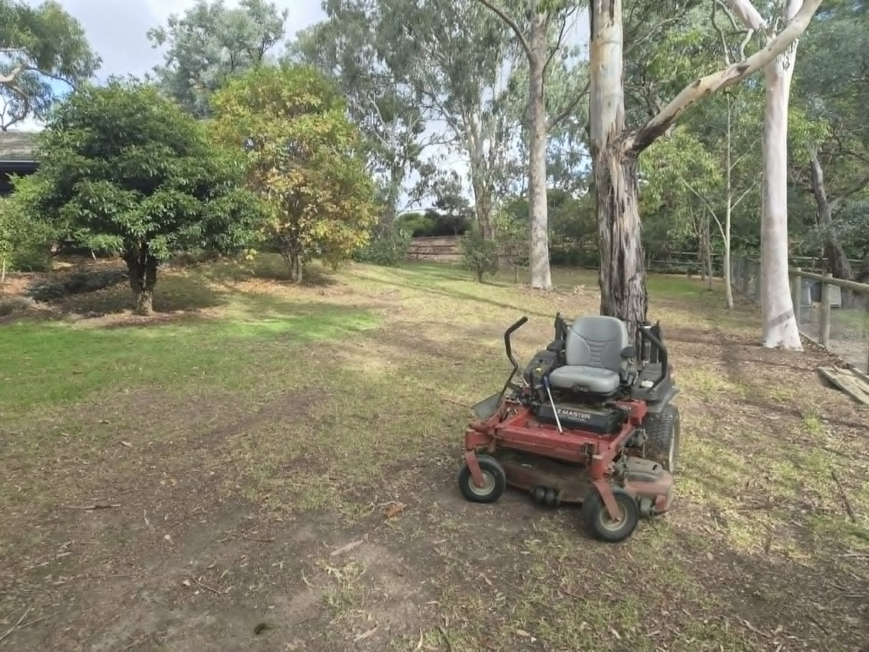 Zero-turn mower on large acreage property