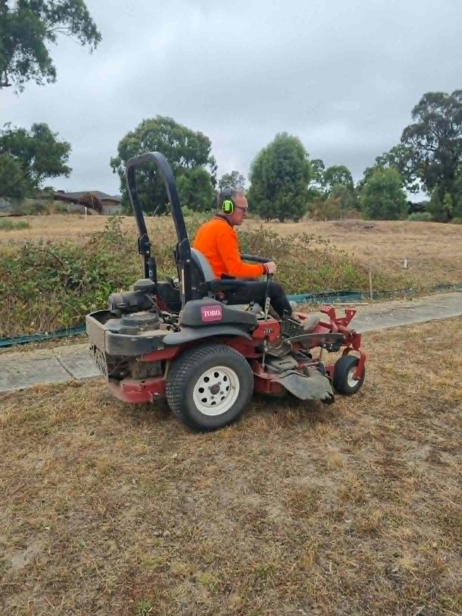 Commercial ride-on mower on council land